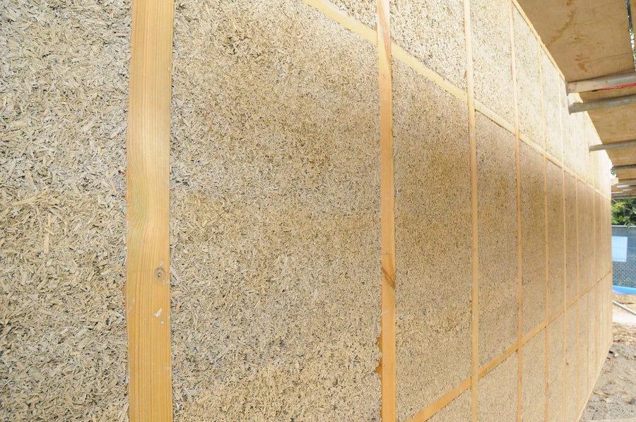 Hempcrete wall insulation made with organic hemp hurd in a timber frame construction wall