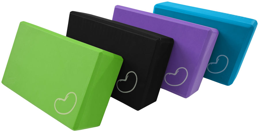Set of lightweight foam yoga blocks in green, black, purple, and blue colors for balance and support in yoga practice