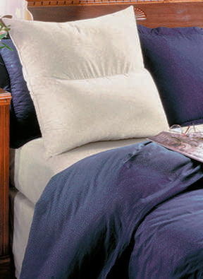 Comfort Reading Pillow propped against bed headboard with blue bedding – supportive backrest pillow for sitting up in bed