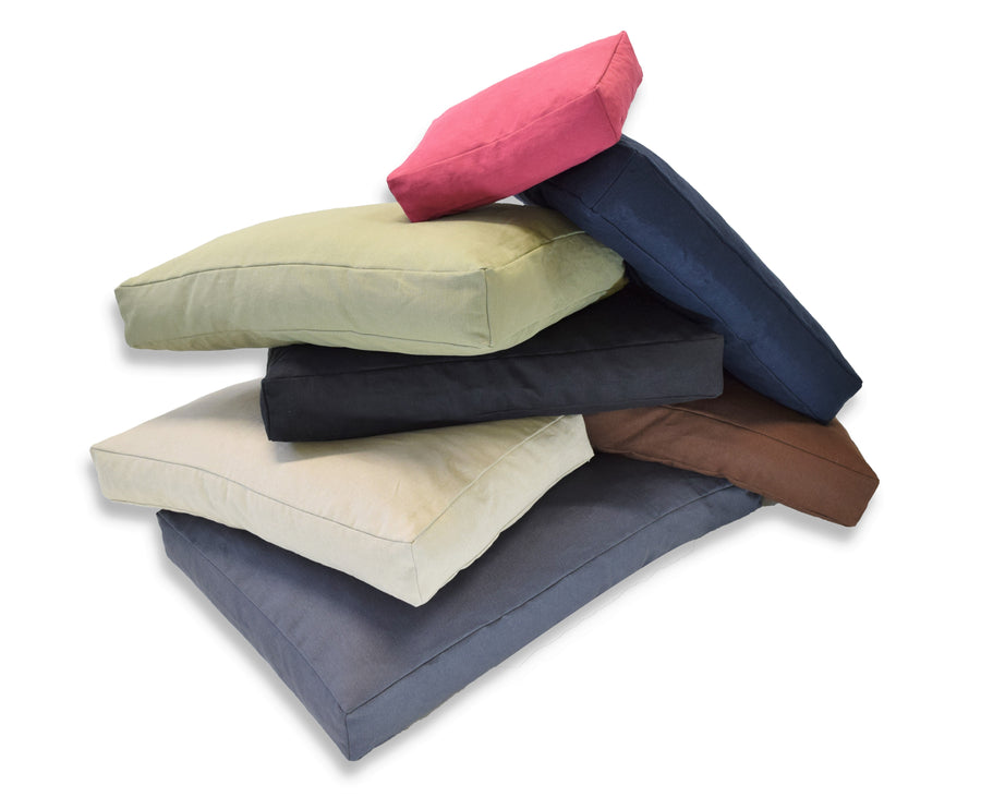 Stack of hemp dog bed covers in assorted colors folded and layered
