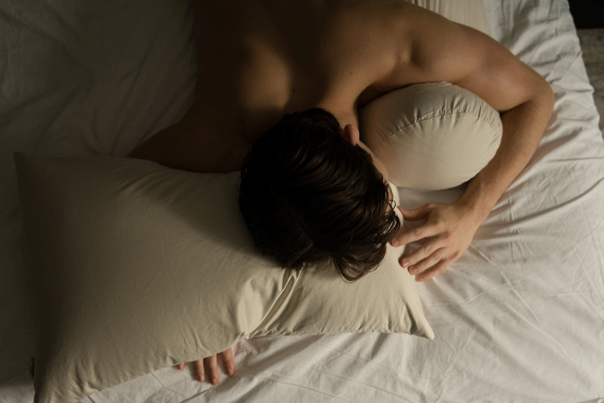 Person sleeping on organic kapok pillow comfortable breathable vegan pillow support