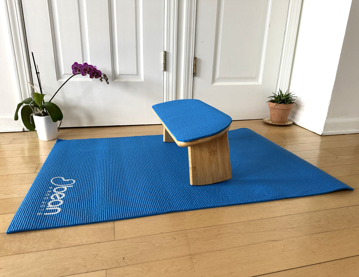 Bamboo meditation bench placed on yoga mat for daily meditation routine