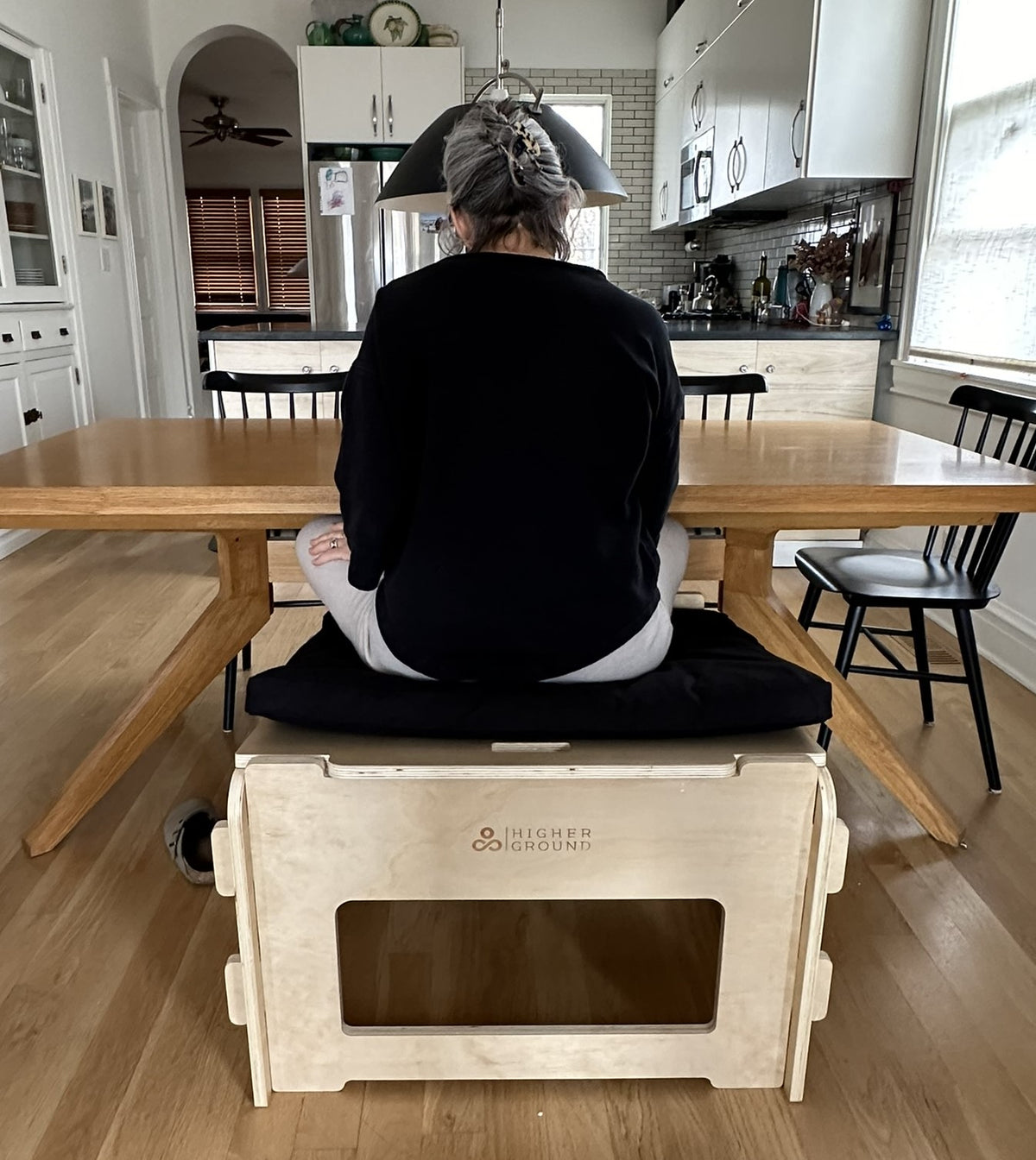 Rear view of ergonomic active sitting chair with wooden base and cushion seat