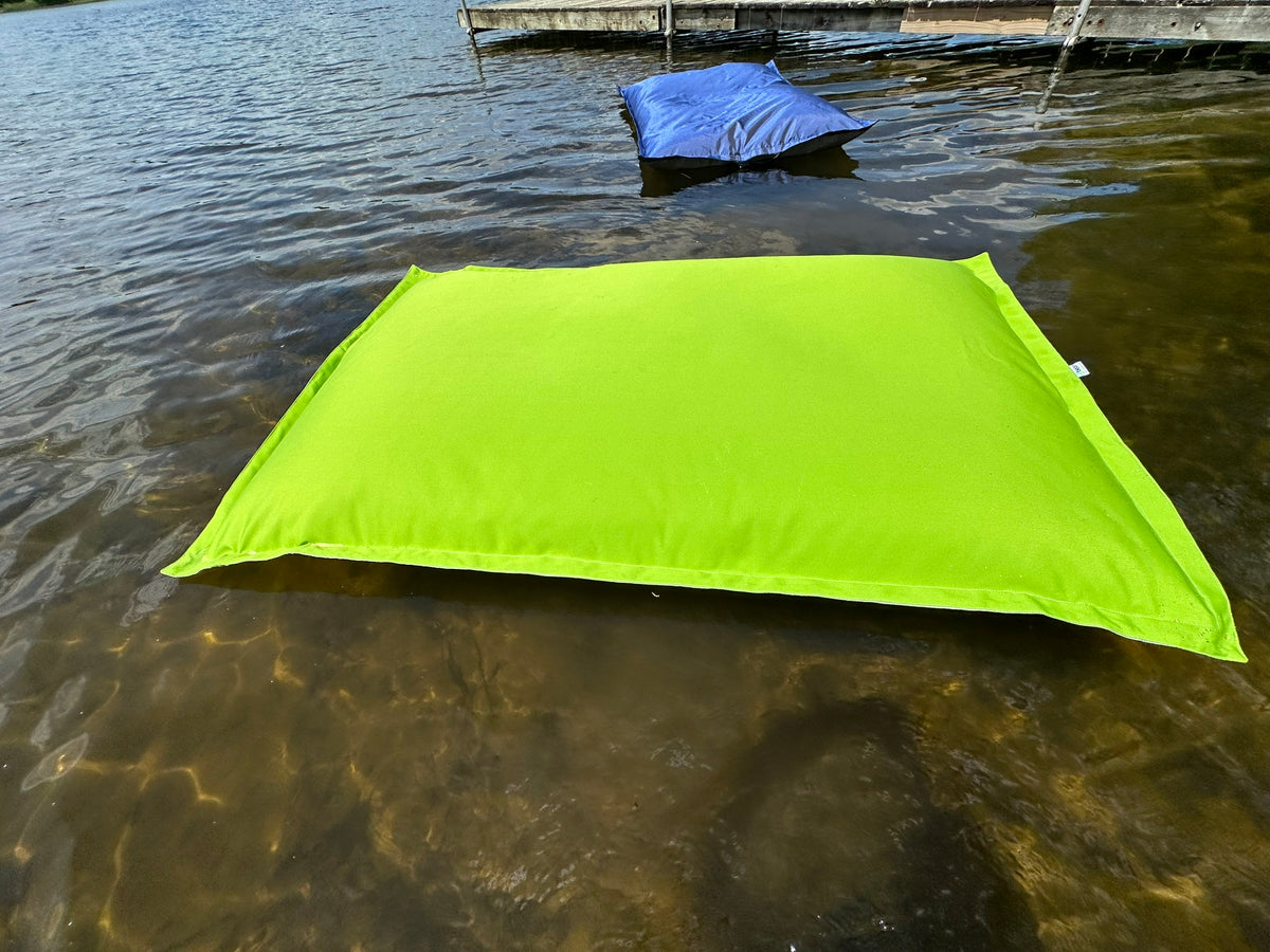Lime Green bean bag pool float in Michigan Lake with smaller blue water float in background by Bean Products made in USA