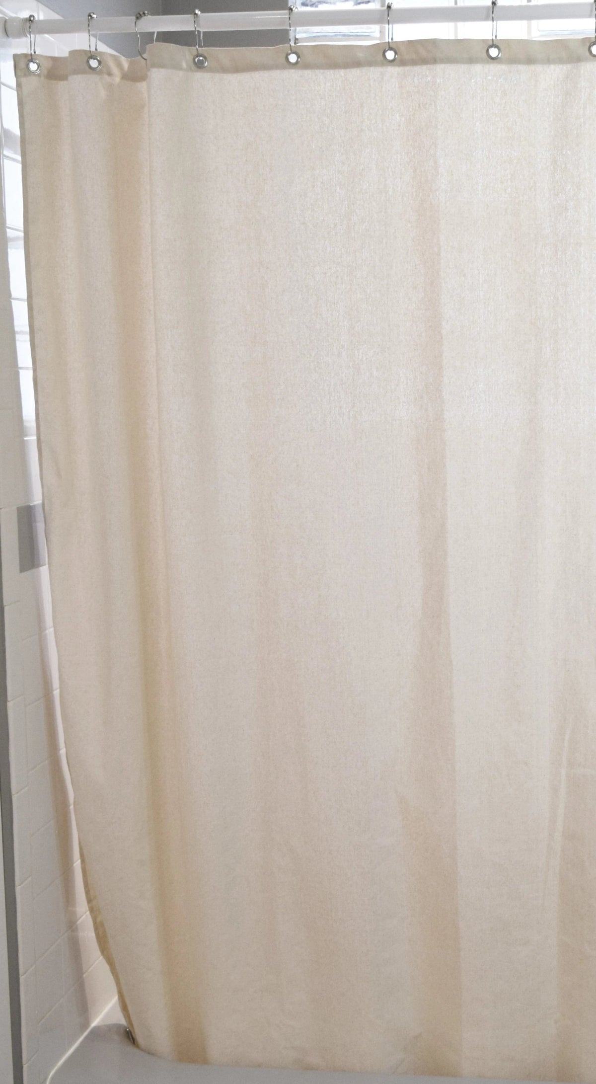 Natural cotton shower curtain full-length view, soft beige bathroom decor