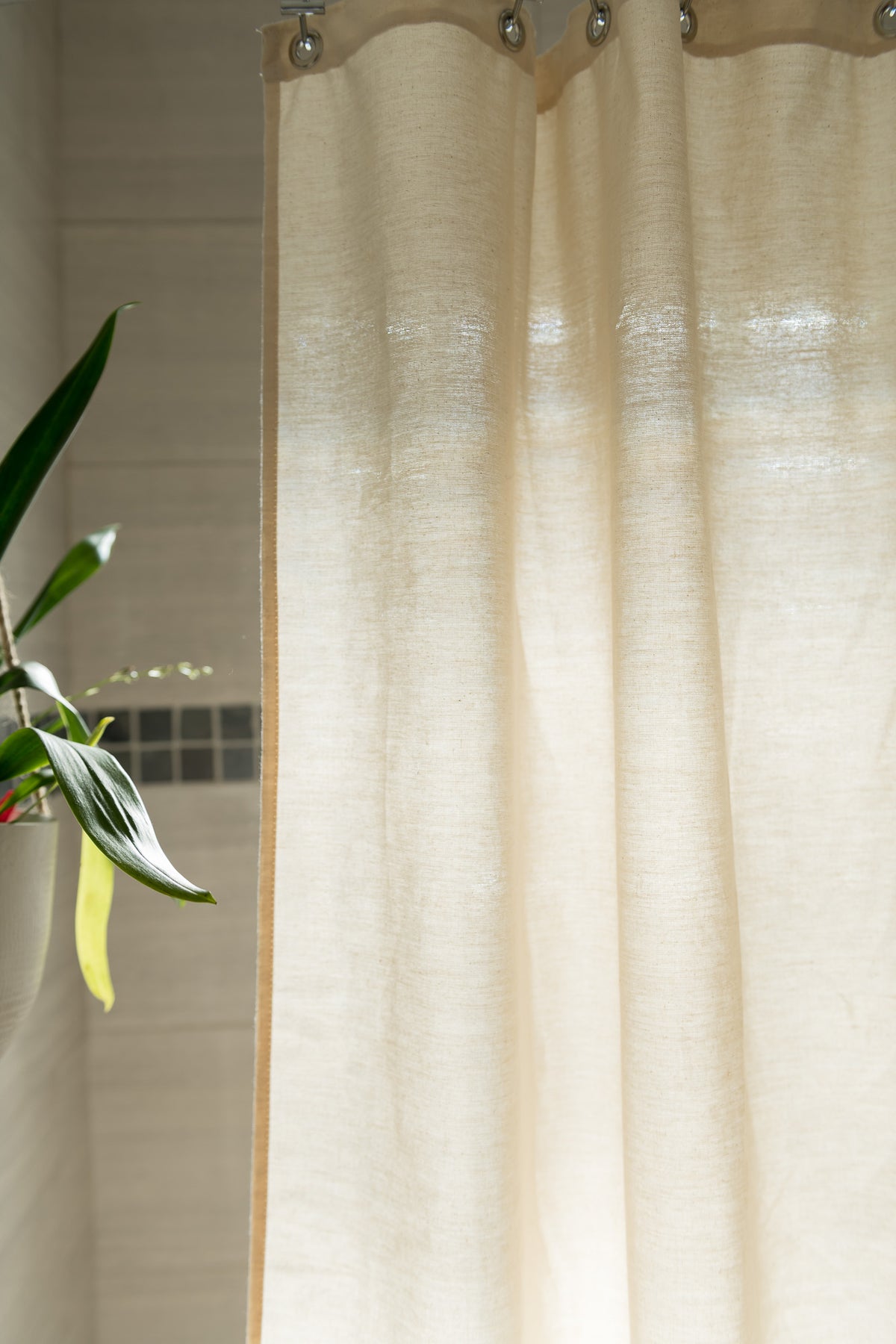 Natural cotton shower curtain fabric detail showing soft weave and light filtering texture