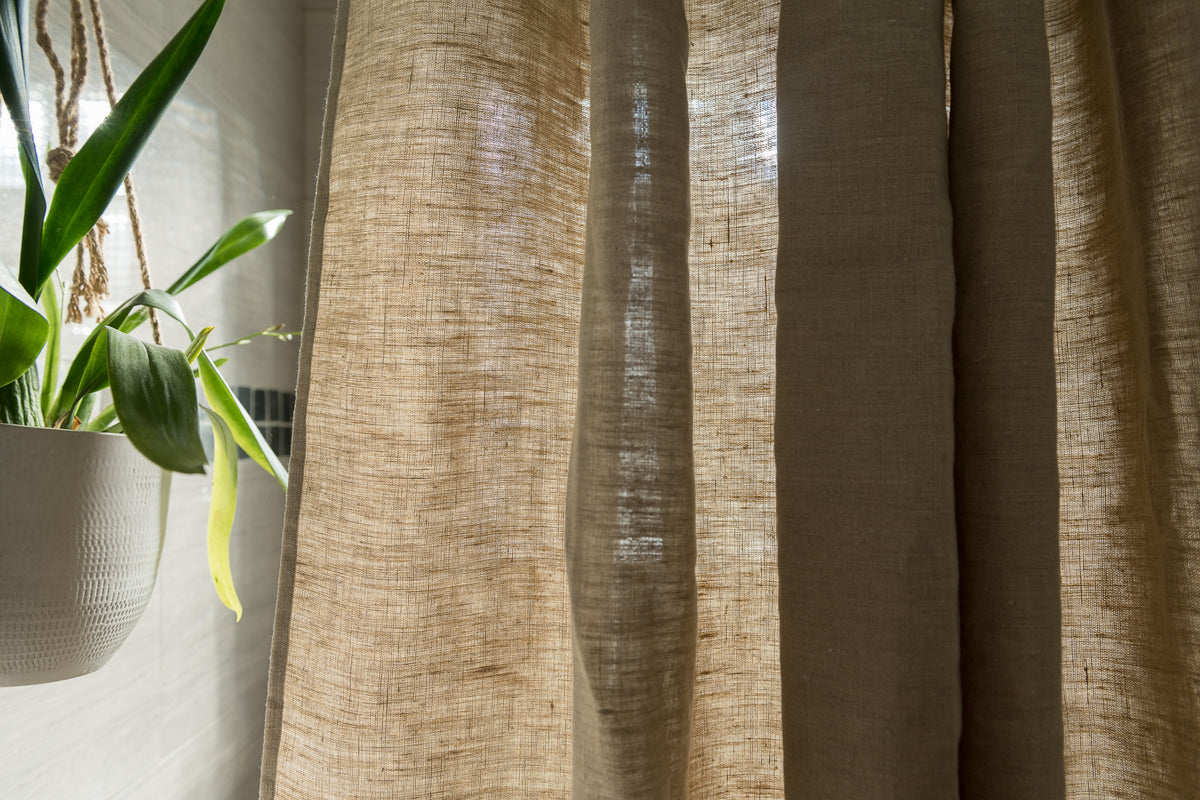 Hemp shower curtain styled in modern bathroom interior