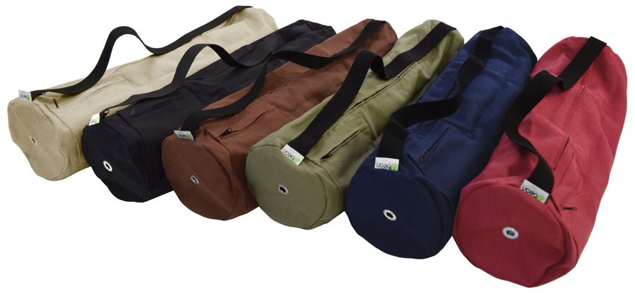 Assorted handcrafted hemp yoga mat bags in multiple colors including black, beige, green, blue, red, and brown