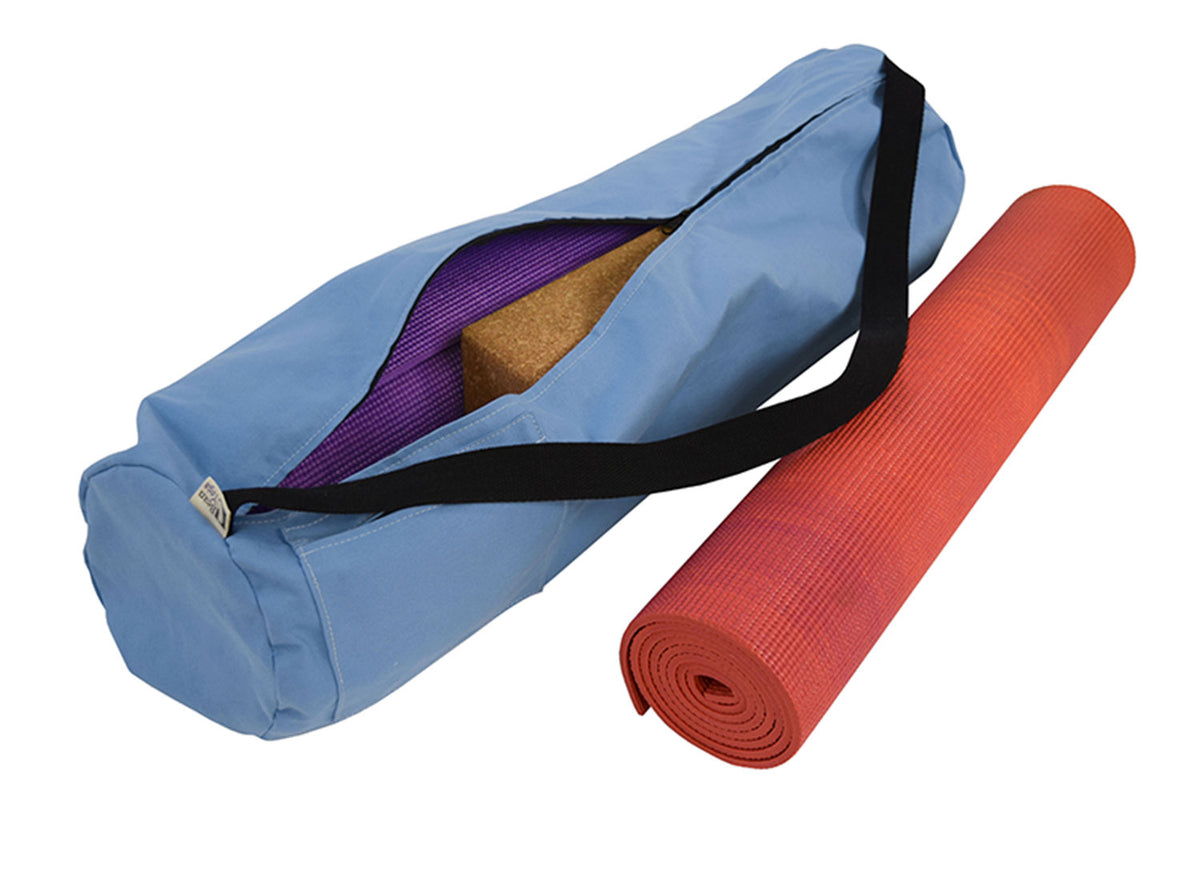 Blue durable cotton yoga mat bag with yoga mat placed beside it