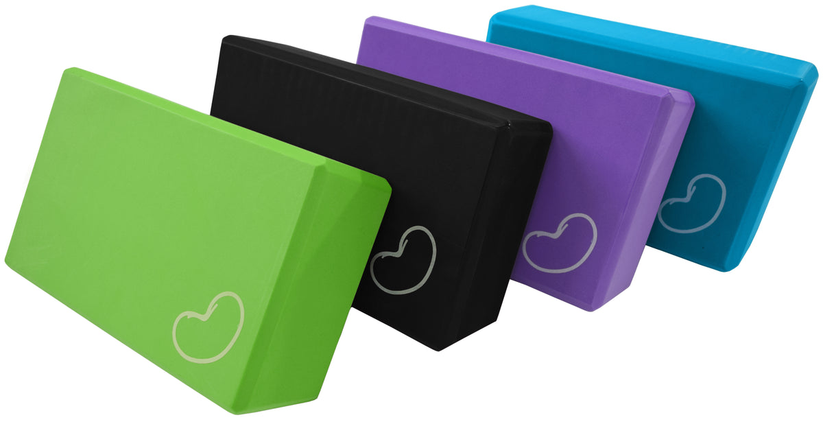 Set of lightweight foam yoga blocks in green, black, purple, and blue colors for balance and support in yoga practice