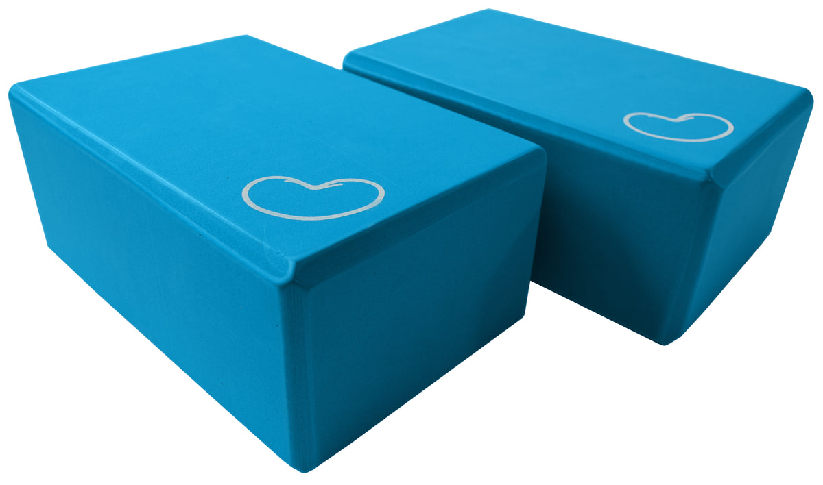 Blue yoga blocks stacked showing ergonomic grip edges for comfort and stability