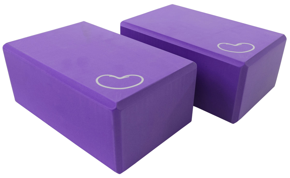 Purple yoga blocks stacked showing high-density foam for balance and support