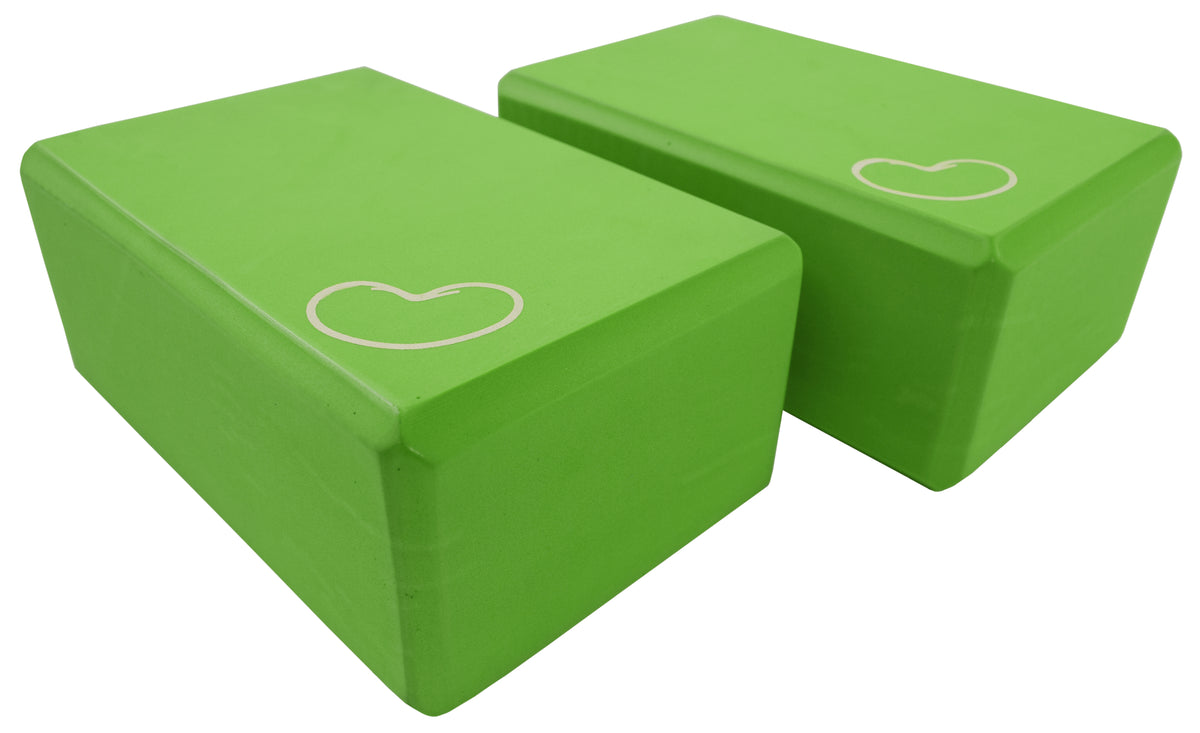 Green yoga blocks stacked showing lightweight foam construction and non-slip grip