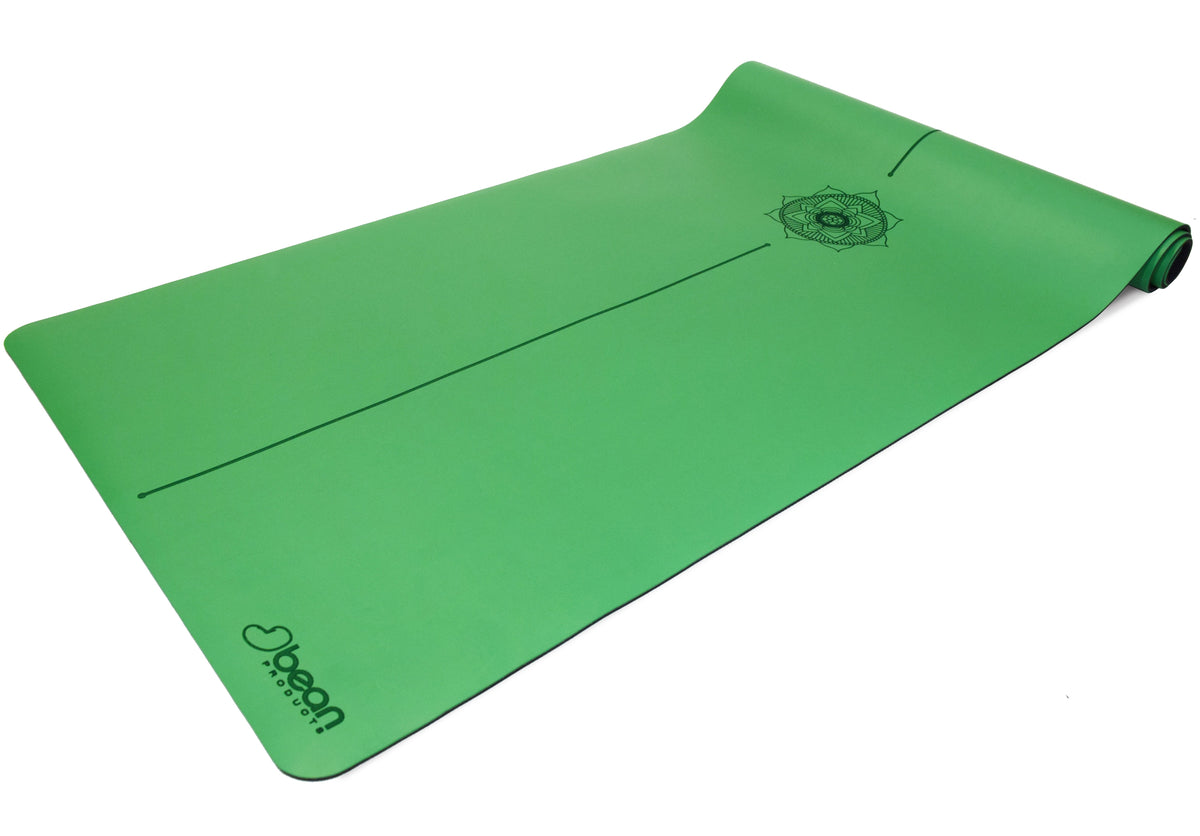 Green eco-friendly yoga mat with non-slip PU coating flat lay view