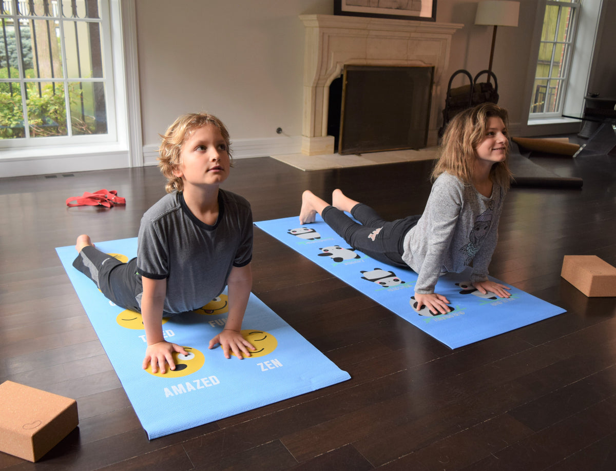 Kids using matching yoga mats for indoor play and stretching, safe eco-friendly material