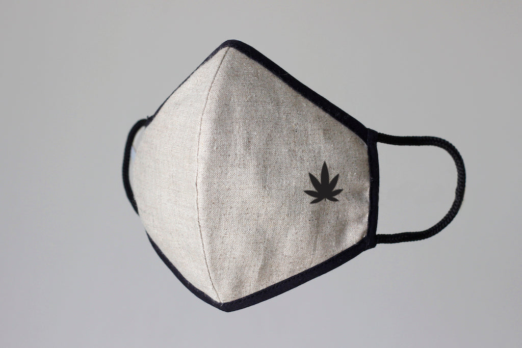 White organic hemp fabric face mask front view, minimalist design with black edging and adjustable ear loops