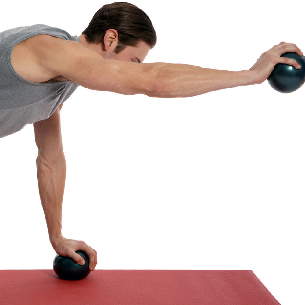 man exercising using soft weighted balls