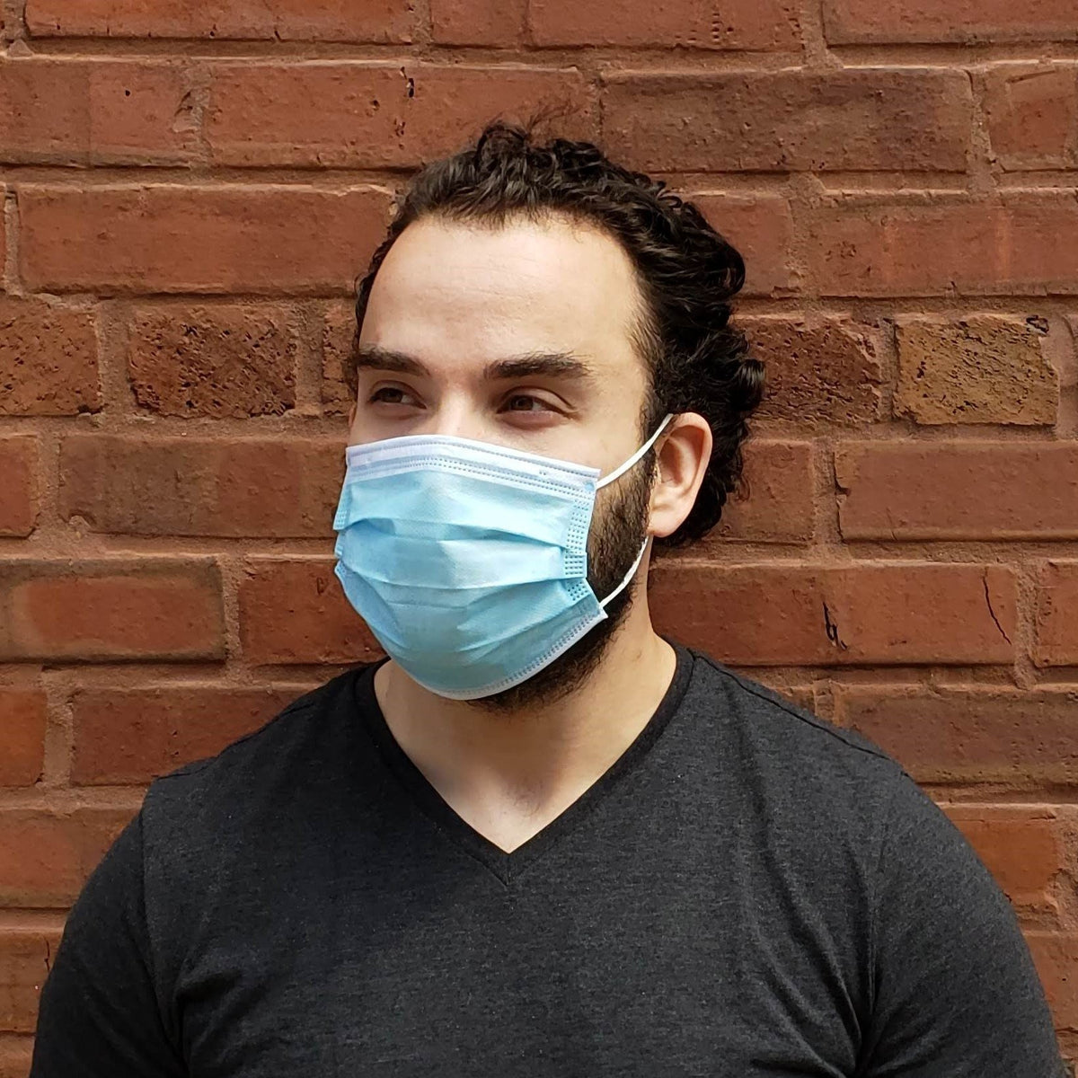 Man wearing blue 3 ply disposable protective face mask