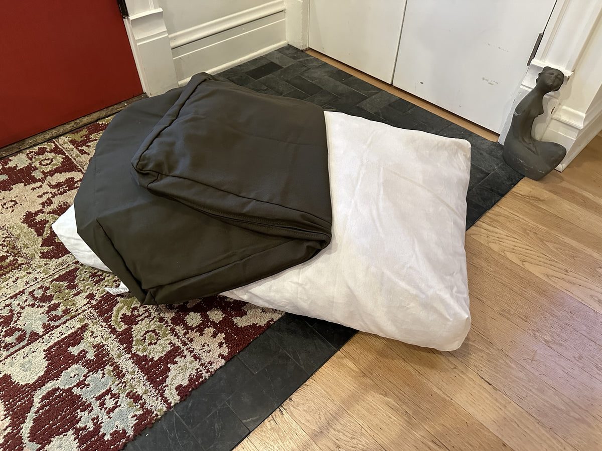 Cotton duck canvas dog bed with dark gray cover and white foam insert partially removed