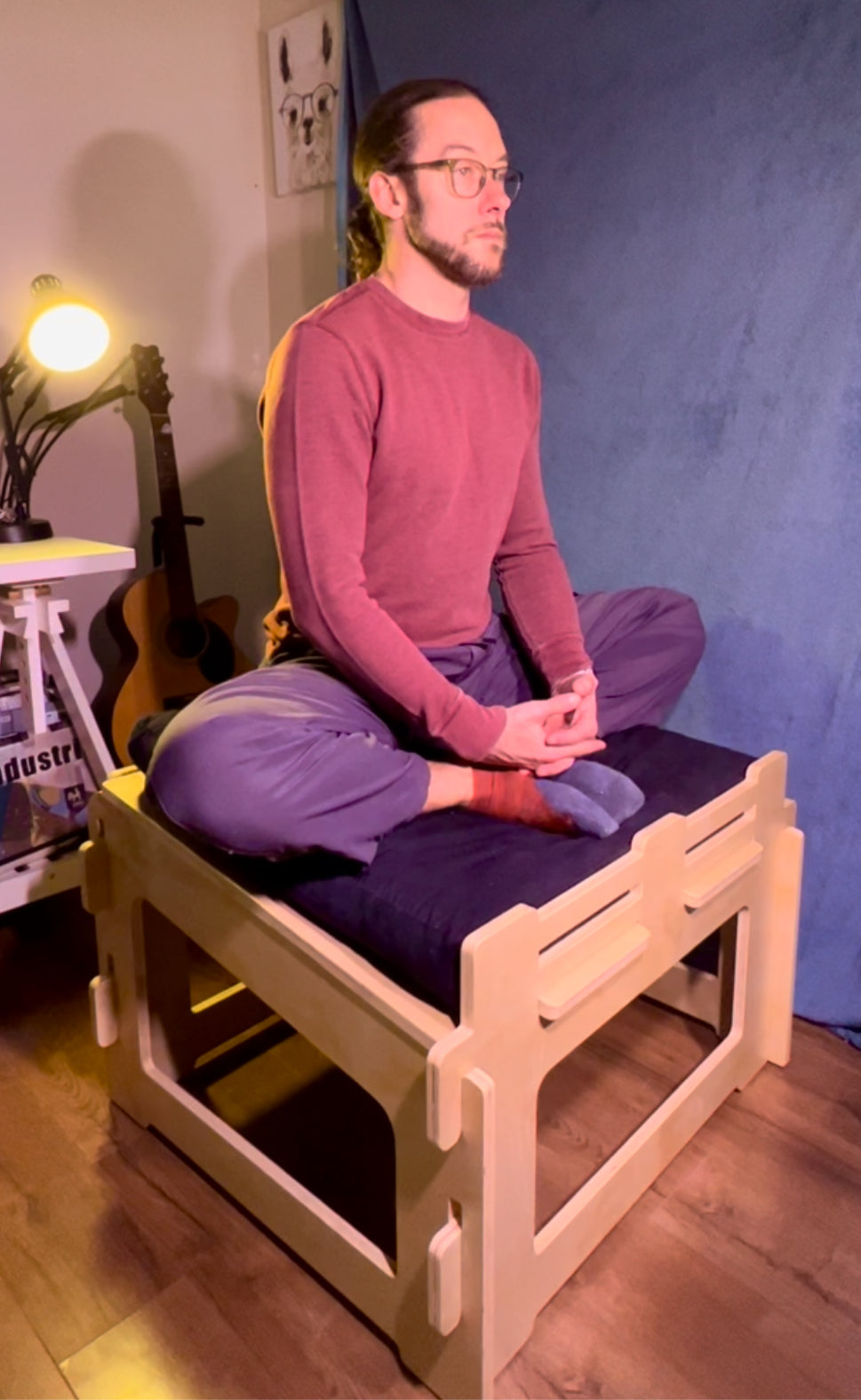 Person practicing meditation on ergonomic active sitting platform chair