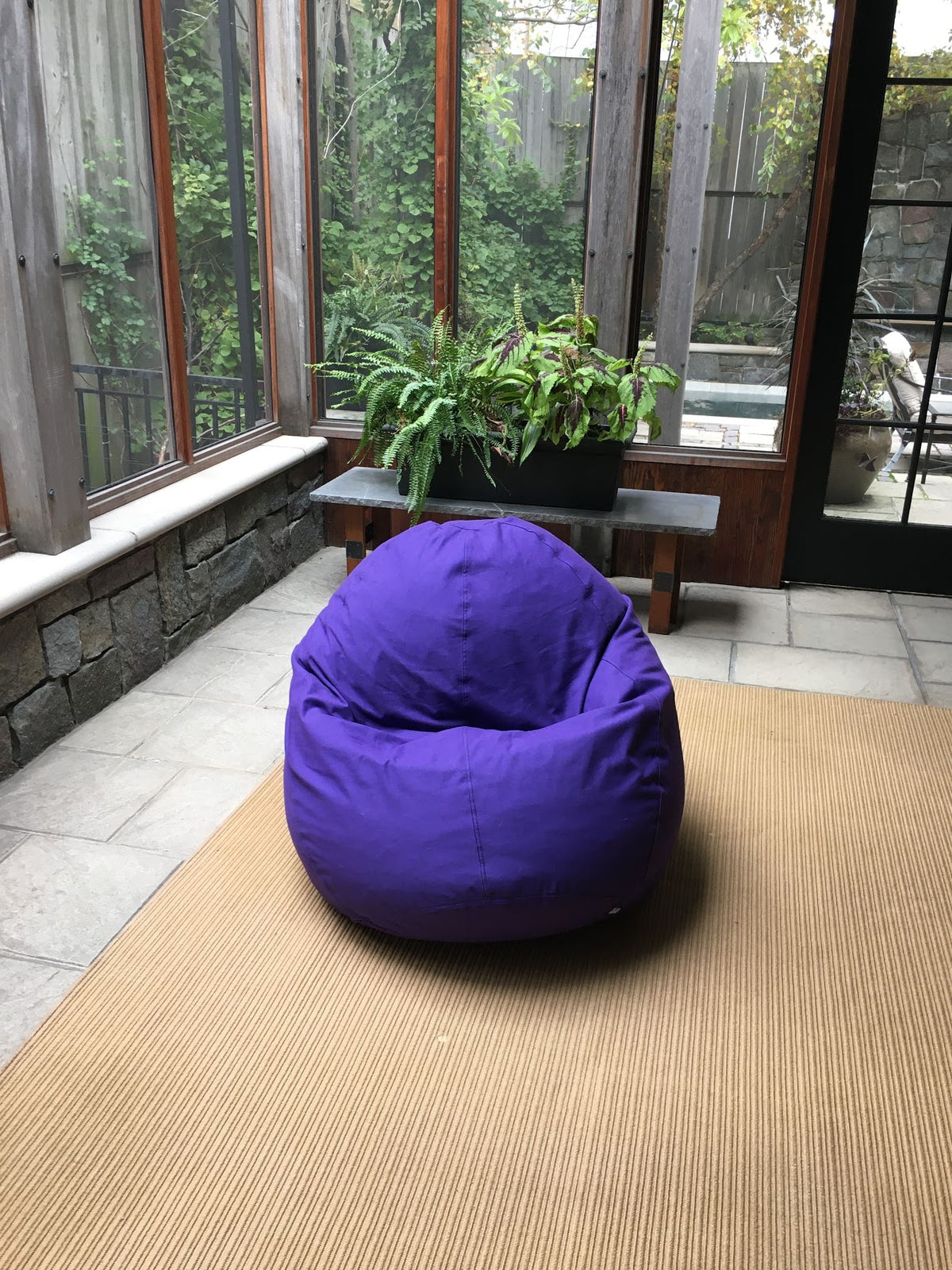Purple bean bag loveseat placed in modern living room setting