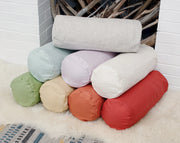 European linen neck roll pillowcases stacked in multiple colors, breathable bolster pillow covers for bedroom decor.