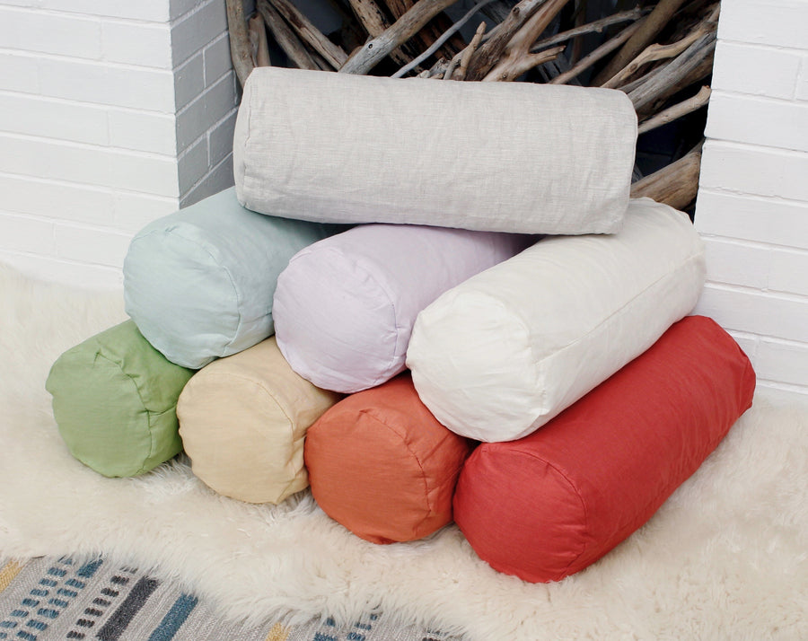 European linen neck roll pillowcases stacked in multiple colors, breathable bolster pillow covers for bedroom decor.