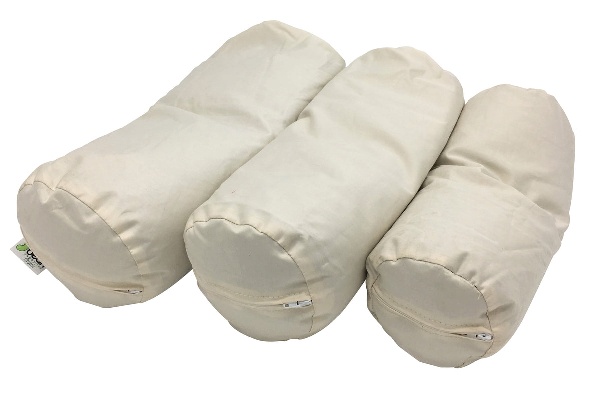 Multiple small neck roll pillows arranged together showing compact size options