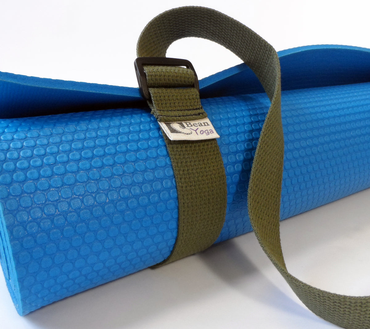 Blue yoga mat wrapped with olive green cotton sling strap and metal buckle detail