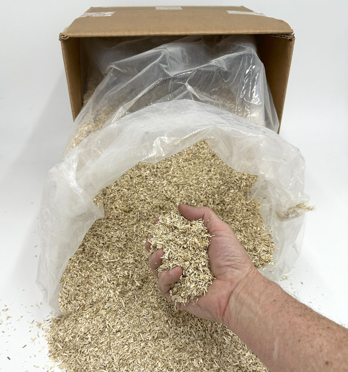 Hand holding hemp bedding showing texture and absorbency organic animal litter close up