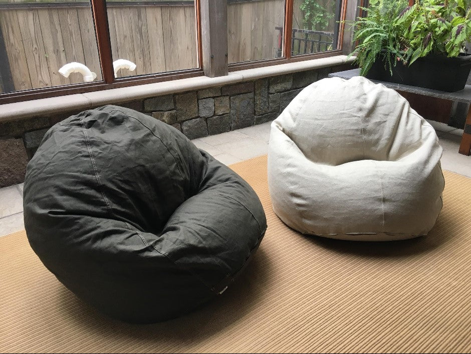 Two ComfyBean adult bean bag loungers in neutral cotton covers placed in a living space