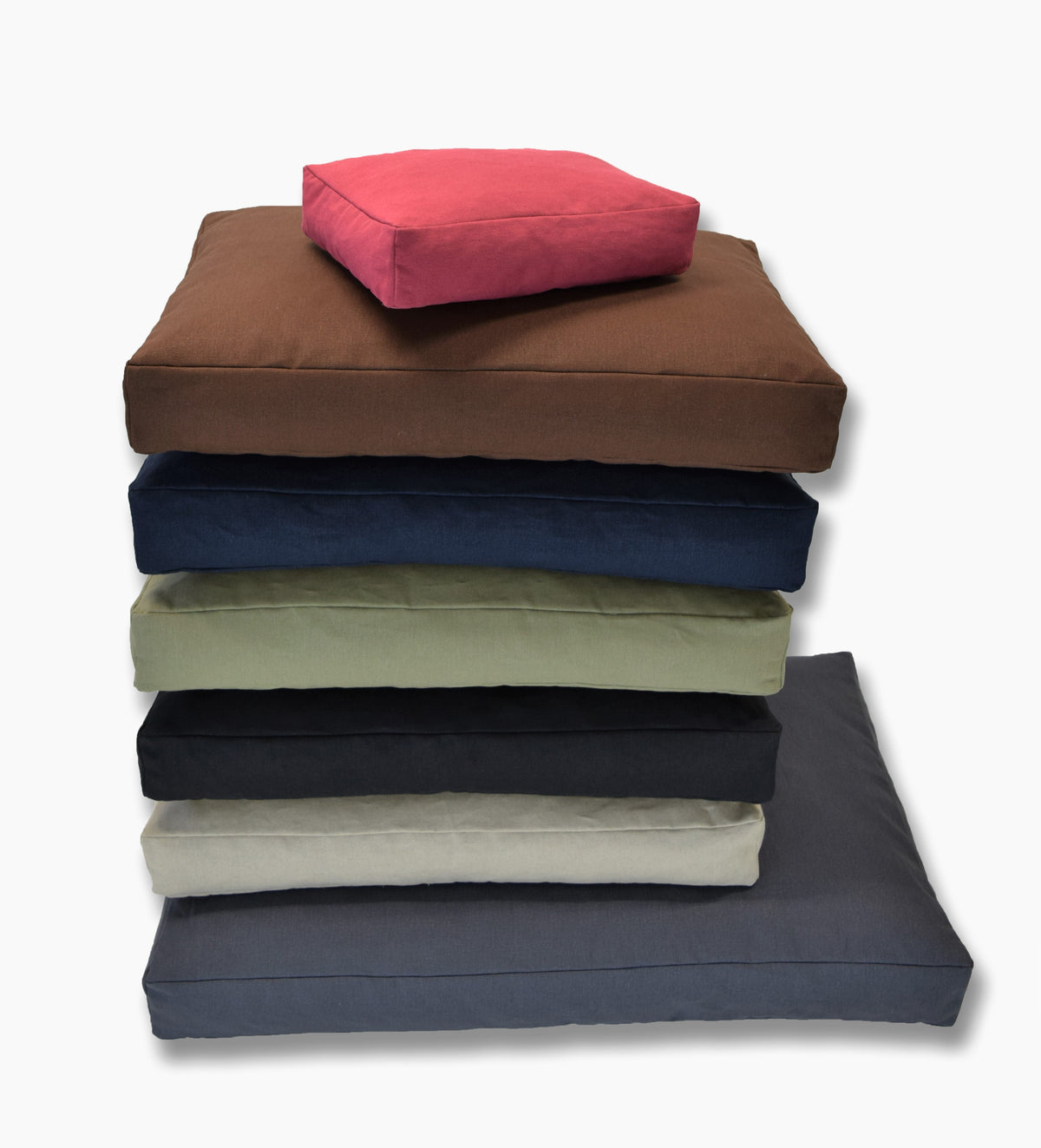 Folded hemp dog bed covers in multiple colors with red cover on top