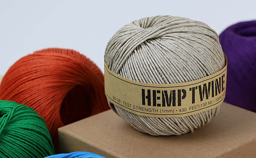 Natural hemp twine ball on a box with colorful cords, eco-friendly hemp rope for gardening, crafting, and jewelry making.